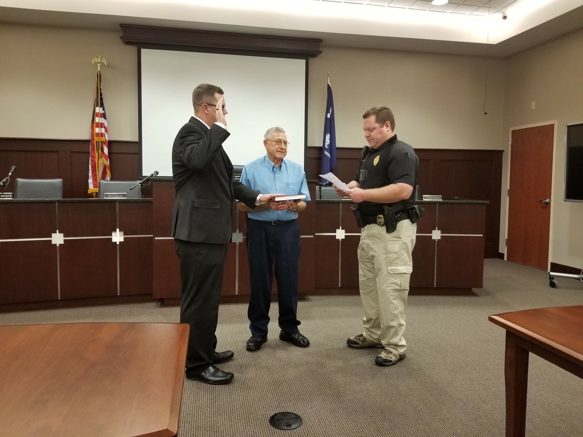 Chapin’s newest police officer Walker Campbell is sworn in by Chief Seth Zeigler as Campbell’s grand